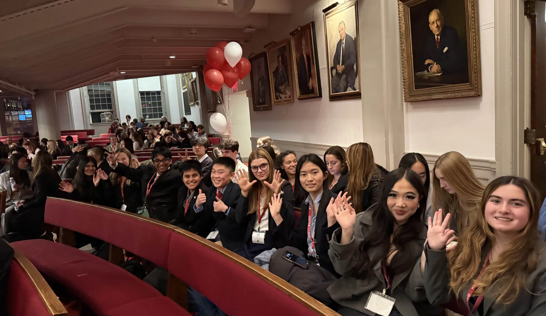 The MUNSDG team smiling and waving together at a Model UN conference